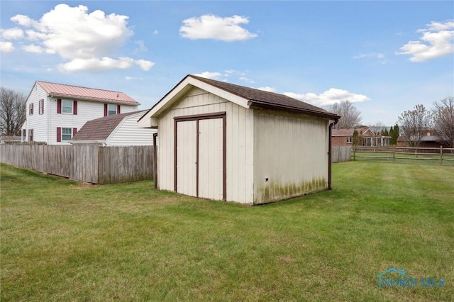 view of outdoor structure featuring a lawn