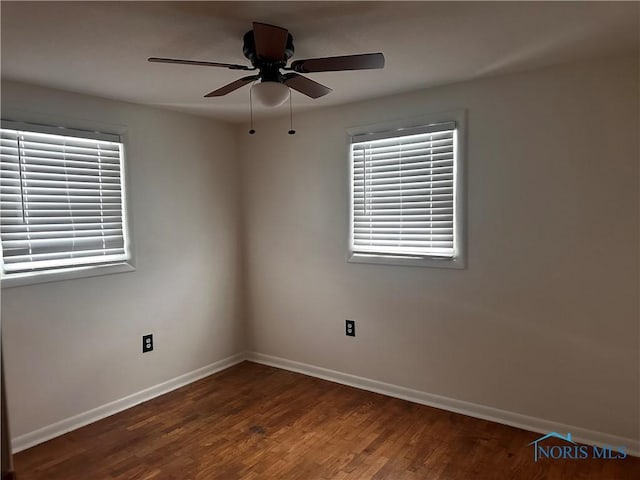 unfurnished room with dark hardwood / wood-style floors and ceiling fan