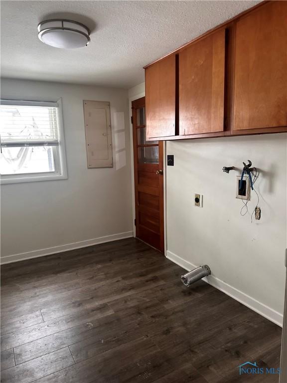 laundry room featuring cabinets, electric dryer hookup, dark hardwood / wood-style floors, electric panel, and hookup for a washing machine