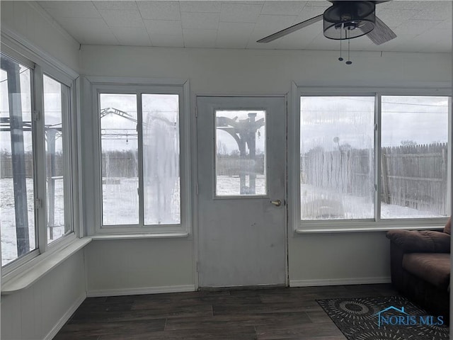 unfurnished sunroom with ceiling fan and a healthy amount of sunlight