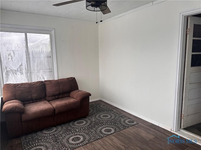 living room featuring dark hardwood / wood-style floors and ceiling fan