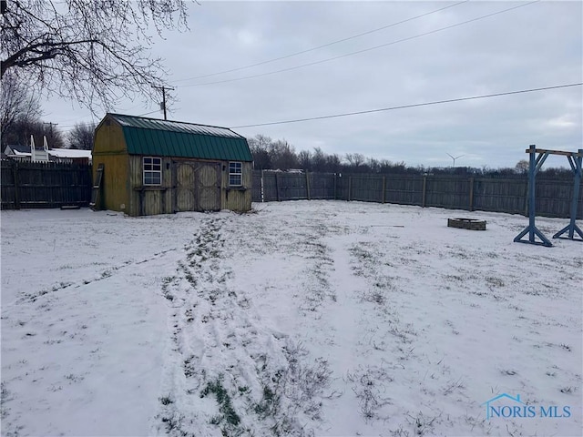 snowy yard with a shed