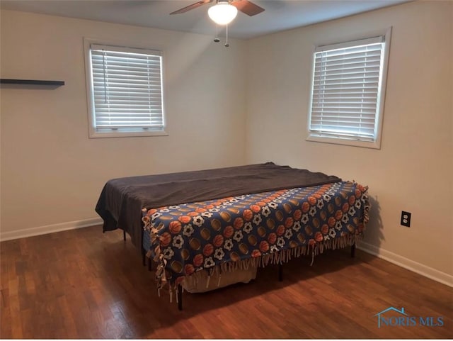 bedroom featuring ceiling fan and dark wood-type flooring