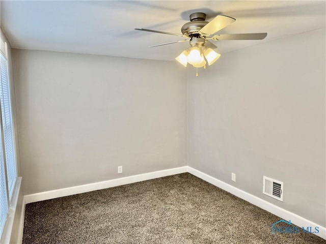 spare room with ceiling fan and carpet