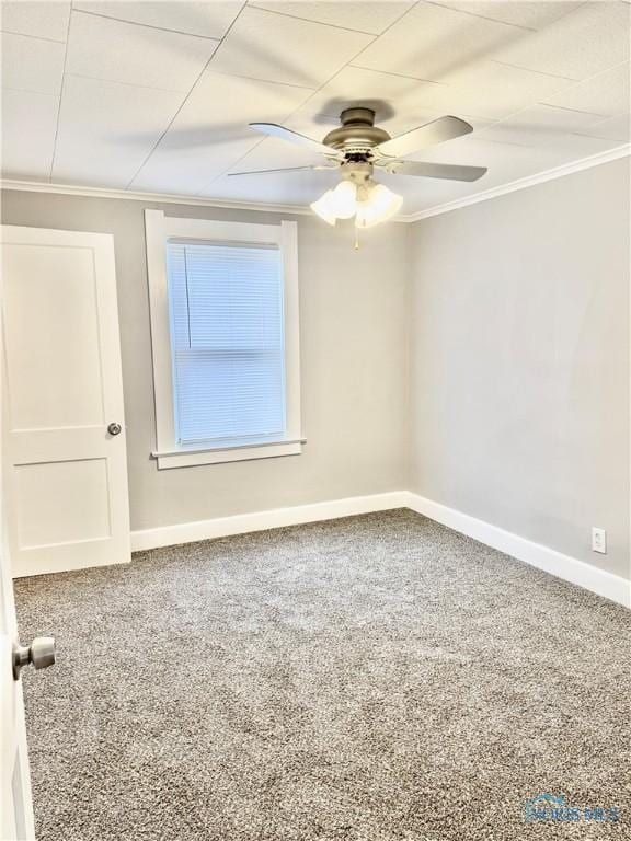 carpeted spare room featuring ceiling fan and crown molding