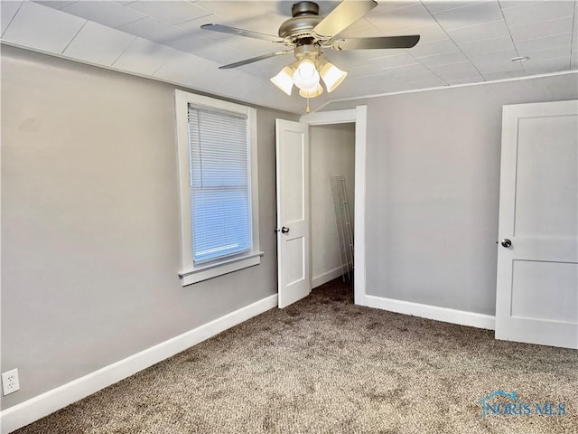 unfurnished bedroom featuring ceiling fan and carpet