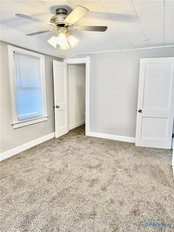 spare room with ceiling fan and carpet flooring