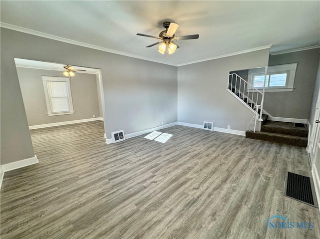 unfurnished living room with ceiling fan, wood-type flooring, and ornamental molding