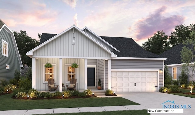 view of front of property featuring a garage and a yard