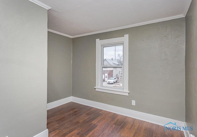 unfurnished room featuring dark hardwood / wood-style flooring and ornamental molding