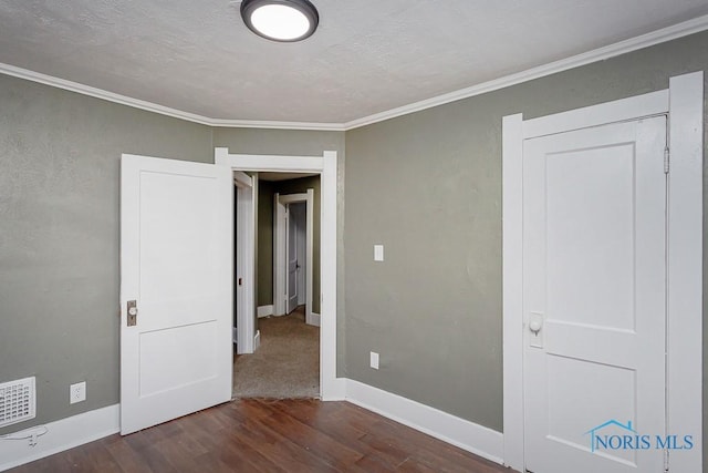 unfurnished bedroom with dark hardwood / wood-style floors and crown molding