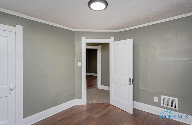 unfurnished room with dark hardwood / wood-style floors and ornamental molding