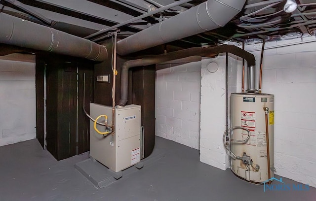 utility room featuring heating unit and gas water heater