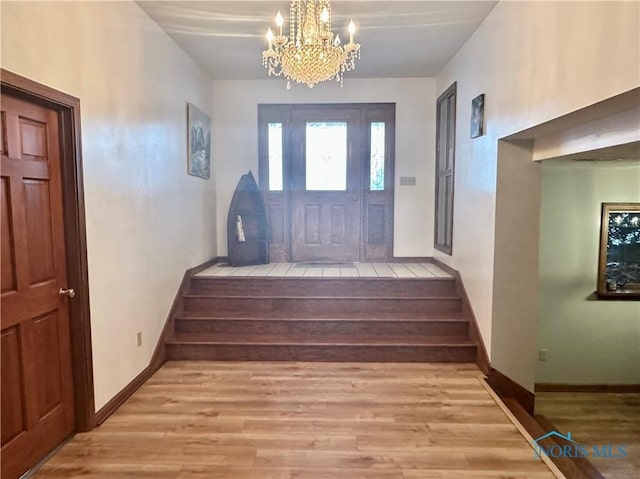 entrance foyer featuring a notable chandelier and light hardwood / wood-style flooring