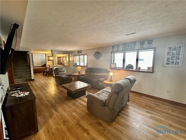 living room featuring a textured ceiling and hardwood / wood-style flooring