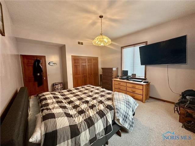 bedroom with light carpet and a closet