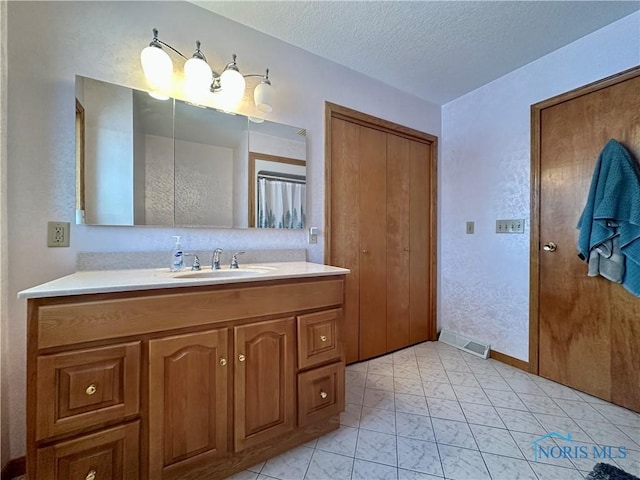 bathroom featuring vanity and a textured ceiling