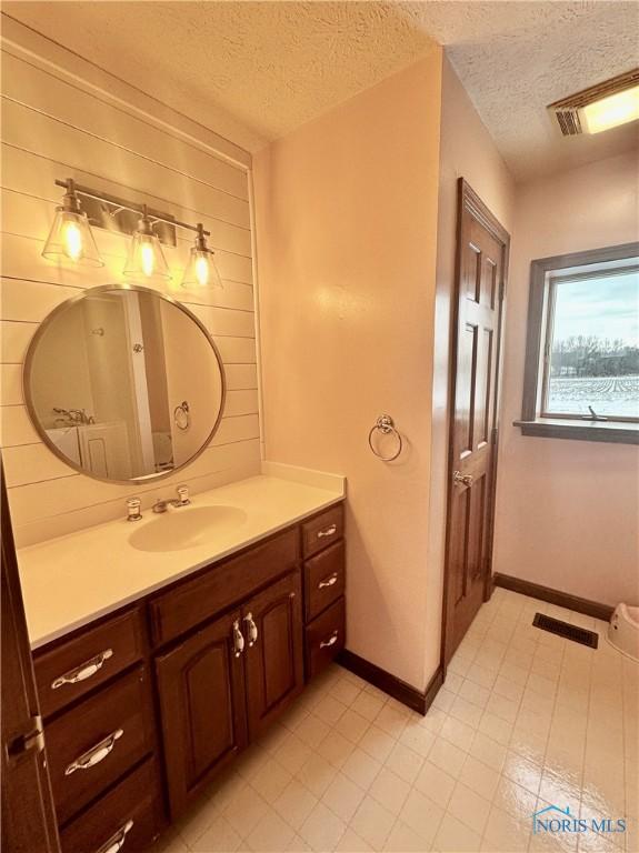 bathroom featuring vanity and a textured ceiling