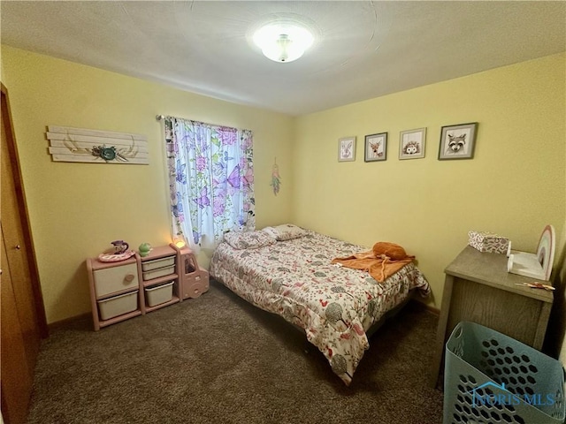 bedroom with dark colored carpet