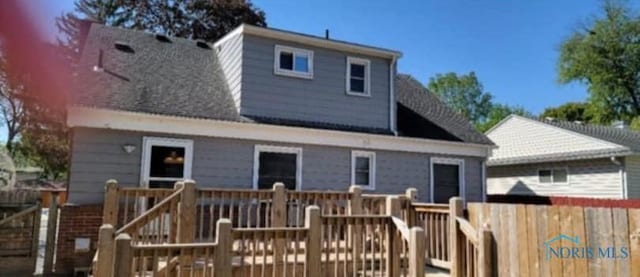 rear view of house with a wooden deck