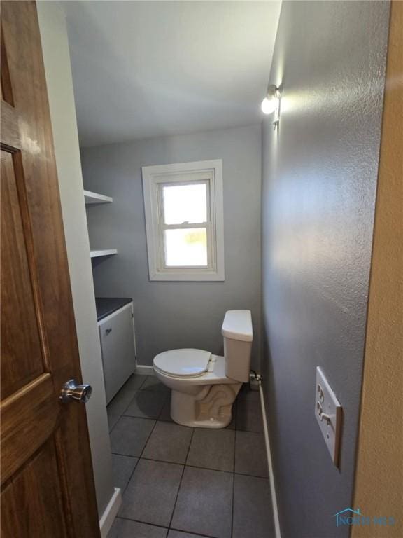 bathroom with vanity, tile patterned floors, and toilet