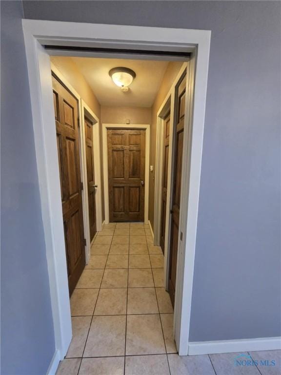 hall featuring light tile patterned floors