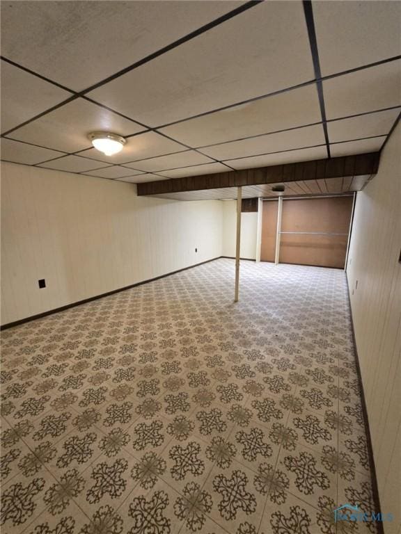 basement featuring a paneled ceiling