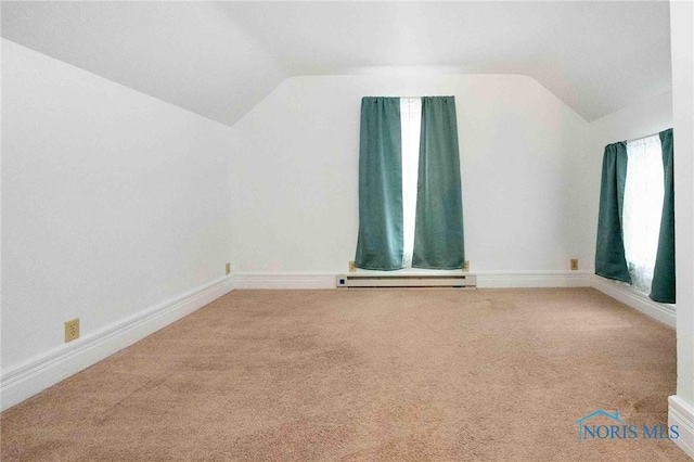 additional living space featuring carpet floors, vaulted ceiling, and a baseboard heating unit