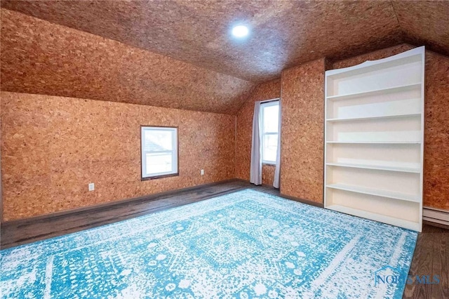 bonus room with vaulted ceiling, dark hardwood / wood-style flooring, and a baseboard radiator