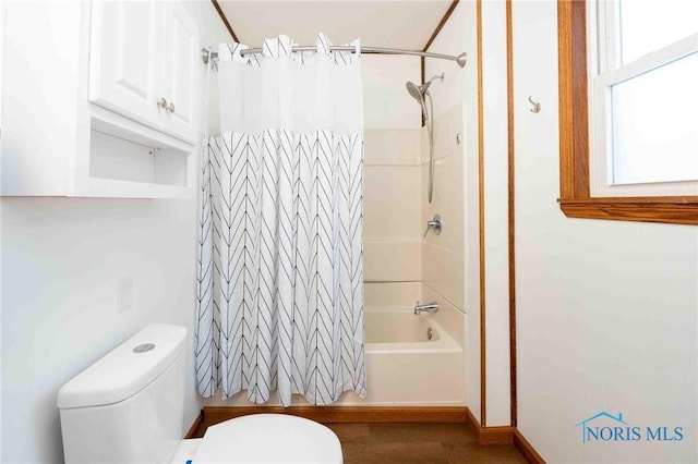 bathroom with toilet and shower / tub combo