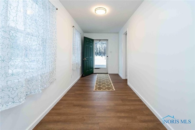 corridor with dark hardwood / wood-style floors