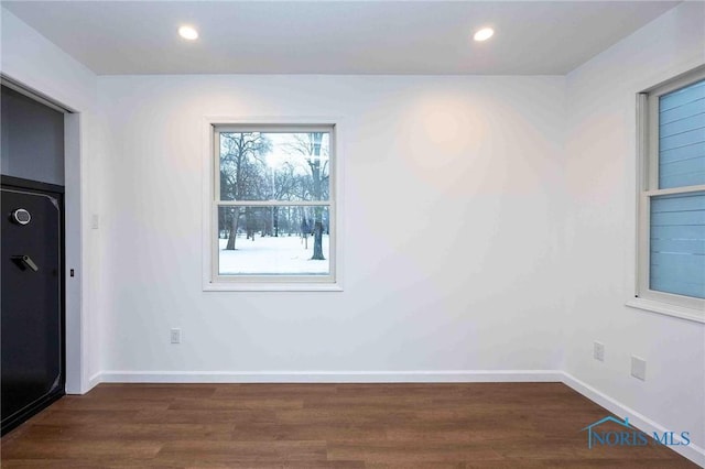 spare room featuring dark hardwood / wood-style flooring