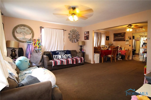 living room featuring carpet, radiator heating unit, and ceiling fan