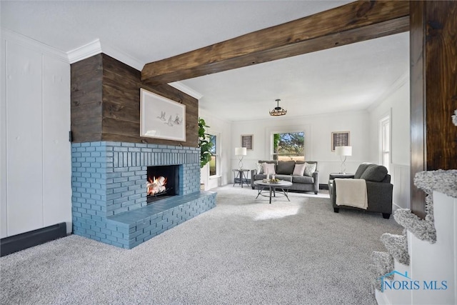 carpeted living room featuring beam ceiling, crown molding, and a fireplace