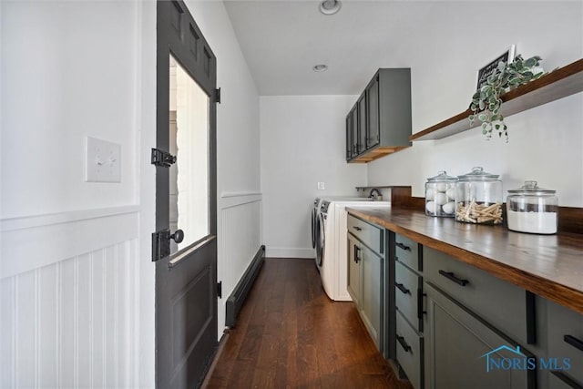 kitchen featuring washer and clothes dryer, wood counters, gray cabinetry, dark wood-type flooring, and a baseboard radiator