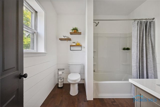 full bathroom featuring vanity, toilet, shower / bathtub combination with curtain, and hardwood / wood-style flooring