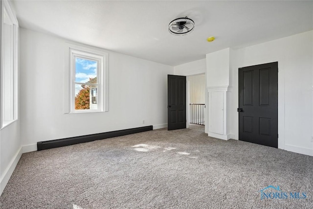 empty room featuring carpet floors and a baseboard radiator