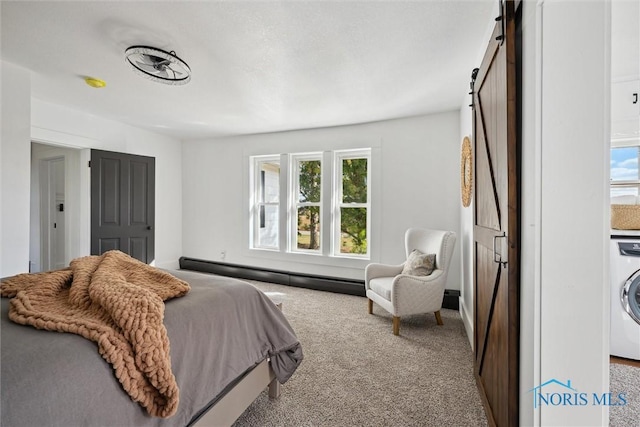 bedroom with carpet flooring, a barn door, multiple windows, and baseboard heating