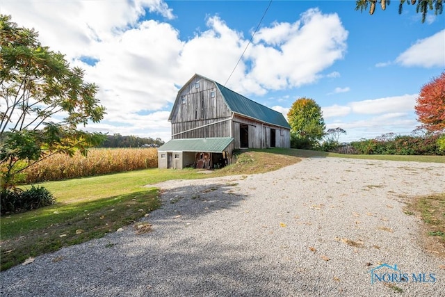 view of front of house with an outbuilding and a front yard