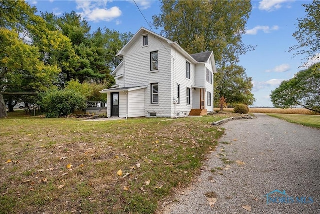 view of home's exterior with a yard