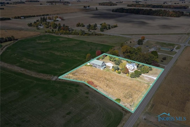 birds eye view of property with a rural view