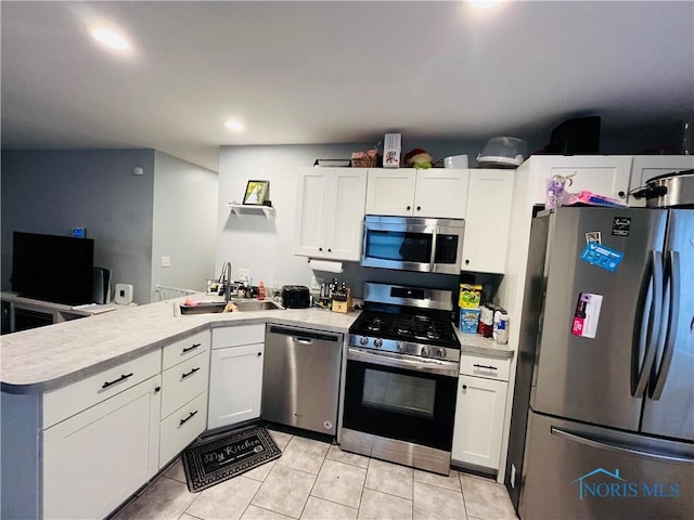 kitchen with white cabinets, stainless steel appliances, and sink