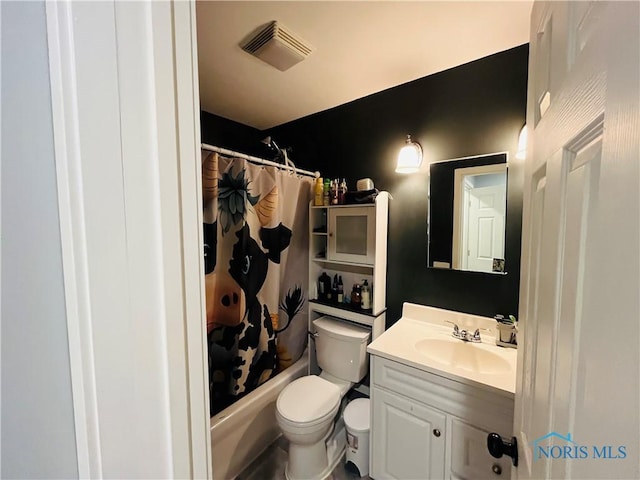 full bathroom featuring vanity, toilet, and shower / tub combo with curtain