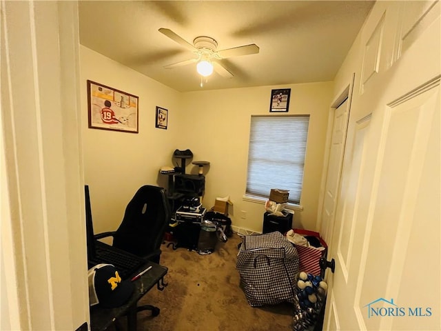 carpeted office featuring ceiling fan