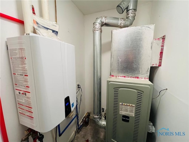 utility room featuring tankless water heater