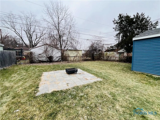 view of yard featuring a patio and an outdoor fire pit