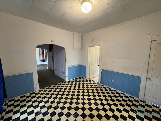 empty room with wooden walls and crown molding