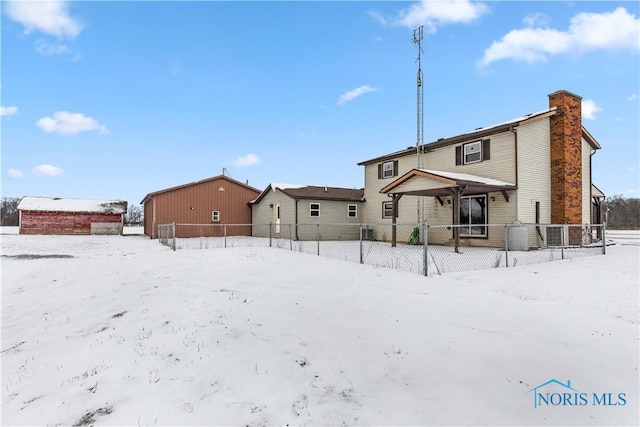 view of snow covered rear of property