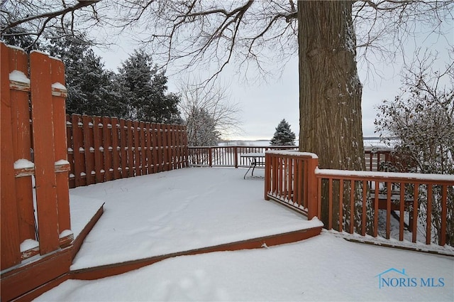 snowy yard featuring a deck