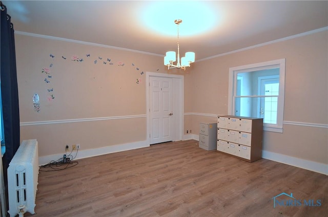 interior space with ornamental molding, radiator, and wood-type flooring